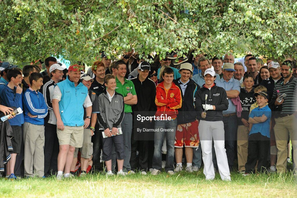 30 July 2011; Rory McIlroy shares a laugh with spectators before playing his shot from the rough under a tree on the 9th hole during the third round of the 2011 Discover Ireland Irish Open Golf Championship, Killarney Golf & Fishing Club, Killarney, Co. Kerry. Picture credit: Diarmuid Greene / SPORTSFILE