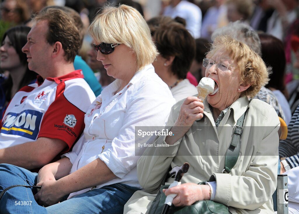 4 August 2011; Mary Smyth, from Ballsbridge, Dublin, enjoys an ice-cream as she watches the ladies day fashion show. Dublin Horse Show 2011, RDS, Ballsbridge, Dublin. Picture credit: Brian Lawless / SPORTSFILE