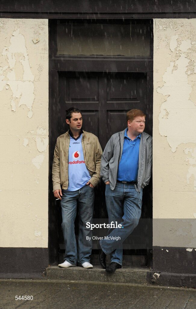 6 August 2011; Dublin fan Darragh Hogan, left, and Chris Hylands, from Drumcondra, Dublin, take shelter from the weather before the GAA Football All-Ireland Senior Championship Quarter-Final, Dublin v Tyrone, Croke Park, Dublin. Picture credit: Oliver McVeigh / SPORTSFILE