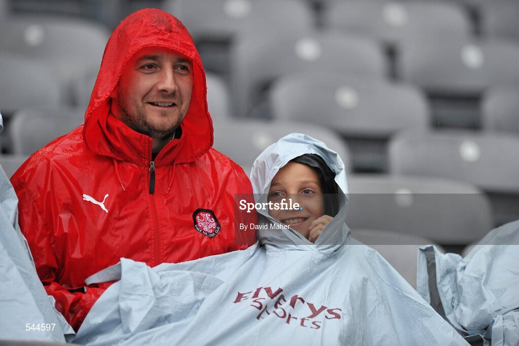 6 August 2011; Tyrone supporters Duane McNally and his son Daniel, from Moortown, Co. Tyrone,  brave the heavy rain before the start of the GAA Football All-Ireland Senior Championship Quarter-Final, Dublin v Tyrone, Croke Park, Dublin. Picture credit: David Maher / SPORTSFILE