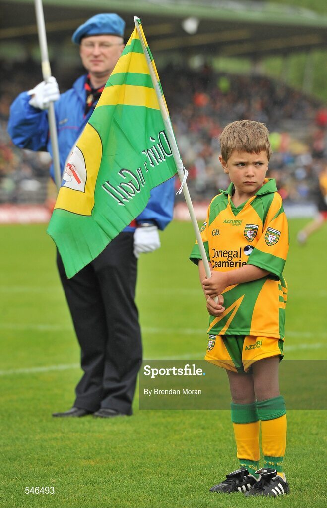 17 July 2011; A young Donegal mascot stands with members of St Michael's Pipe Band, Enniskillen, as they entertain the crowd before the game. Ulster GAA Football Senior Championship Final, Derry v Donegal, St Tiernach's Park, Clones, Co. Monaghan. Picture credit: Brendan Moran / SPORTSFILE