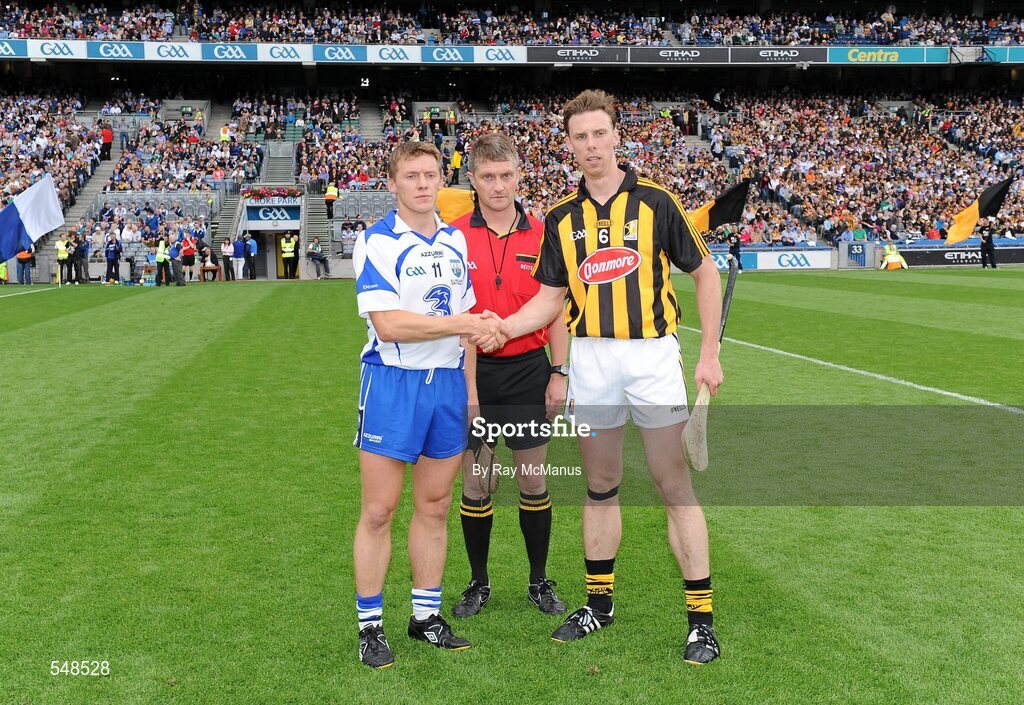7 August 2011; Waterford captain Stephen Molumphy, left, and Kilkenny captain Brian Hogan shake hands in front of referee Barry Kelly. GAA Hurling All-Ireland Senior Championship Semi-Final, Kilkenny v Waterford, Croke Park, Dublin. Picture credit: Ray McManus / SPORTSFILE