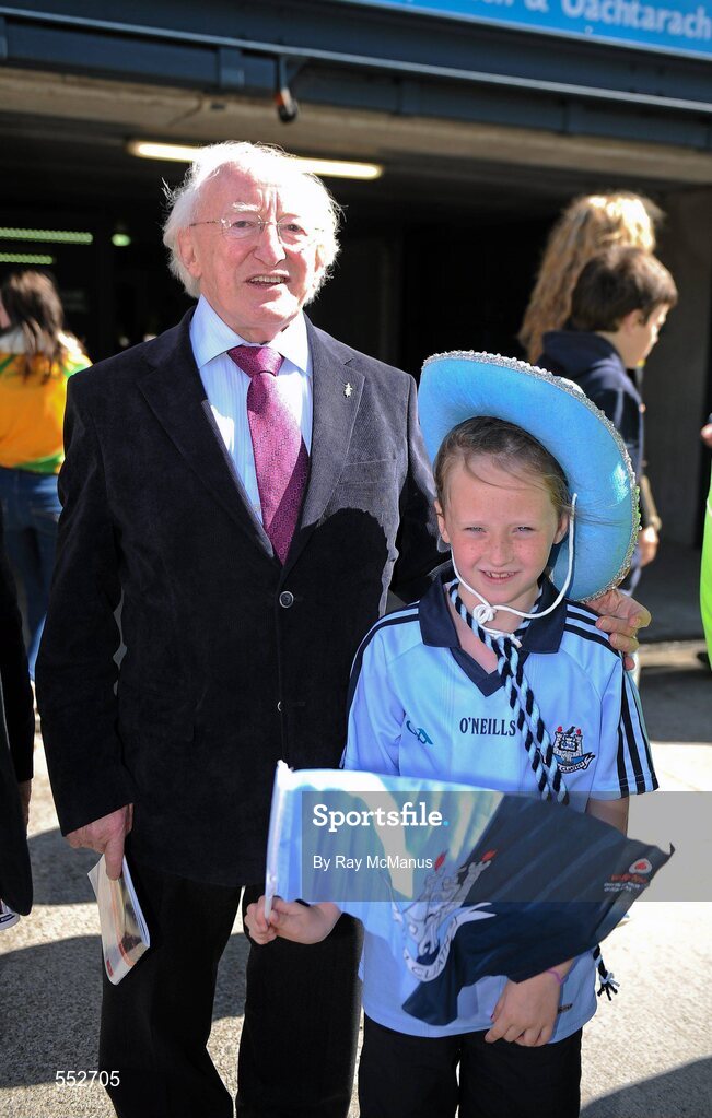 28 August 2011; Labour Presidential candidate Michael D. Higgins with Louise Hopkins, age 7, from Ringsend, Dublin, on their way to the GAA Football All-Ireland Championship Semi-Finals, Croke Park, Dublin. Picture credit: Ray McManus / SPORTSFILE