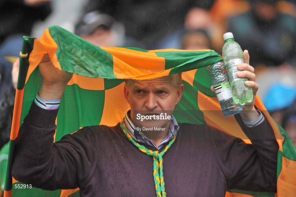 28 August 2011; A Donegal supporter shelters from the heavy rain before the start of the game. Supporters at the GAA Football All-Ireland Championship Semi-Finals, Croke Park, Dublin. Picture credit: David Maher / SPORTSFILE
