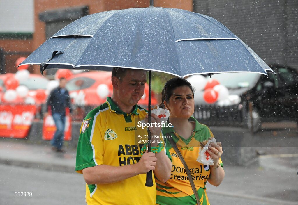 28 August 2011; Donegal supporters Padraig Boyce, and Emma McMonagle, from Letterkenny, Co. Donegal, shelter under an umbrella on Jones' Road. Supporters at the GAA Football All-Ireland Championship Semi-Finals, Croke Park, Dublin. Picture credit: Dáire Brennan / SPORTSFILE