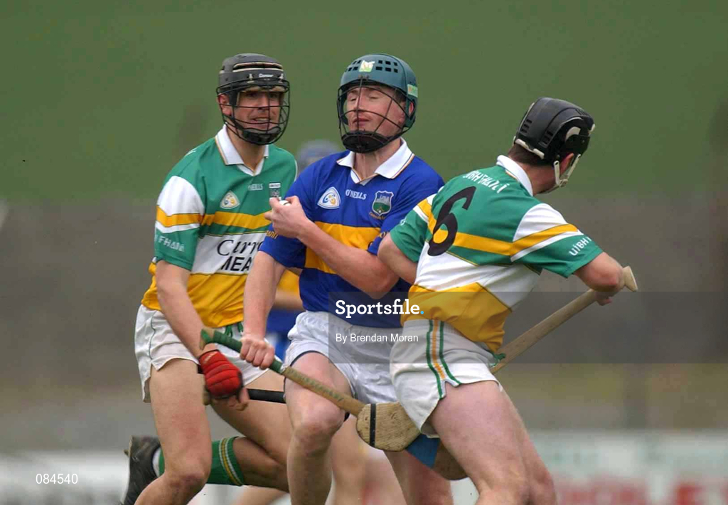 30 March 2002; David Kennedy of Tipperary in action against Hubert Rigney, 6, and Gary Hannify of Offaly during the Allianz National Hurling League Division 1B Round 1 match between Offaly and Tipperary in St Brendan's Park in Birr, Offaly. Photo by Brendan Moran/Sportsfile