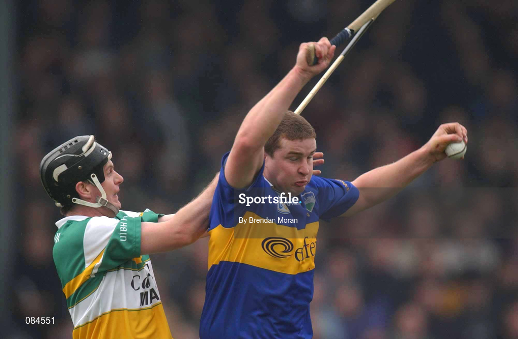 30 March 2002; John Carroll of Tipperary in action against Hubert Rigney of Offaly during the Allianz National Hurling League Division 1B Round 1 match between Offaly and Tipperary in St Brendan's Park in Birr, Offaly. Photo by Brendan Moran/Sportsfile