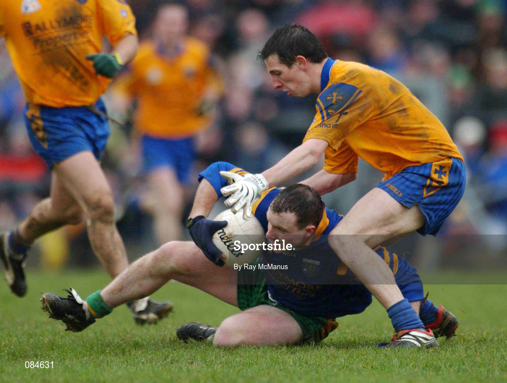 31 March 2002; Adrian Sweeney of Donegal is tackled by John Whyte of Roscommon during the Allianz Football League Division 1A Round 7 match between Roscommon and Donegal at Dr Hyde Park in Roscommon. Please note Donegal wore the Roscommon  away strip due to a clash of jerseys. Photo by Ray McManus/Sportsfile