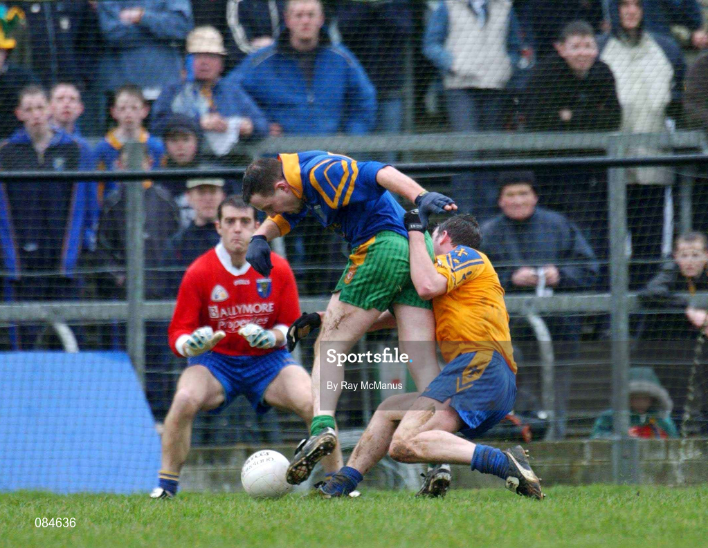 31 March 2002; Adrian Sweeney of Donegal is fouled by David Casey of Roscommon before he was awarded a penalty during the Allianz Football League Division 1A Round 7 match between Roscommon and Donegal at Dr Hyde Park in Roscommon. Please note Donegal wore the Roscommon  away strip due to a clash of jerseys. Photo by Ray McManus/Sportsfile
