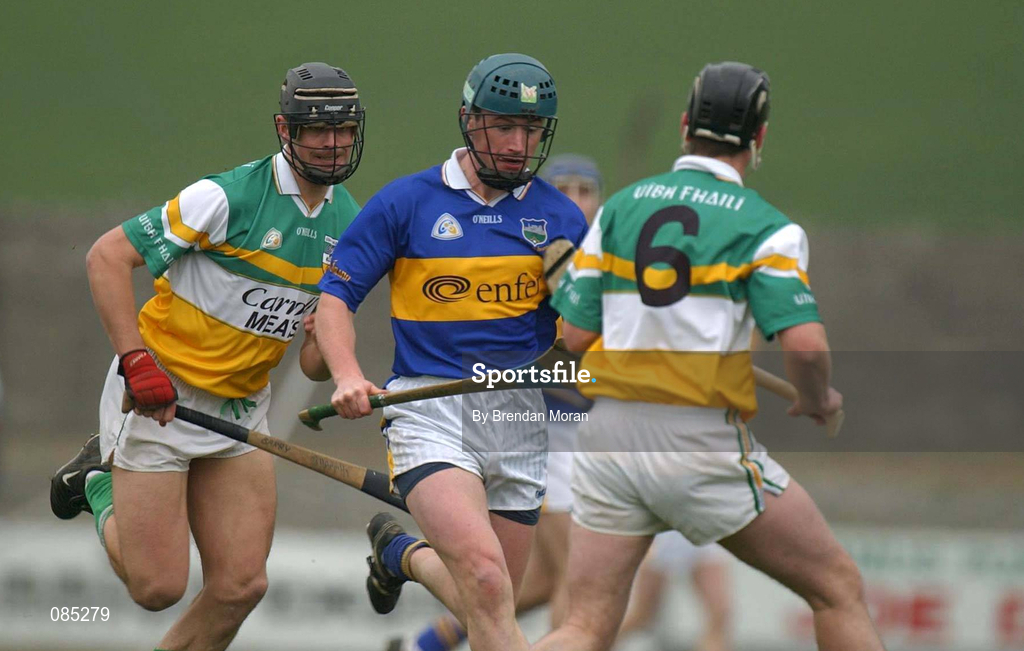 30 March 2002; David Kennedy of Tipperary in action against Hubert Rigney, 6, and Gary Hannify of Offaly during the Allianz National Hurling League Division 1B Round 1 match between Offaly and Tipperary in St Brendan's Park in Birr, Offaly. Photo by Brendan Moran/Sportsfile
