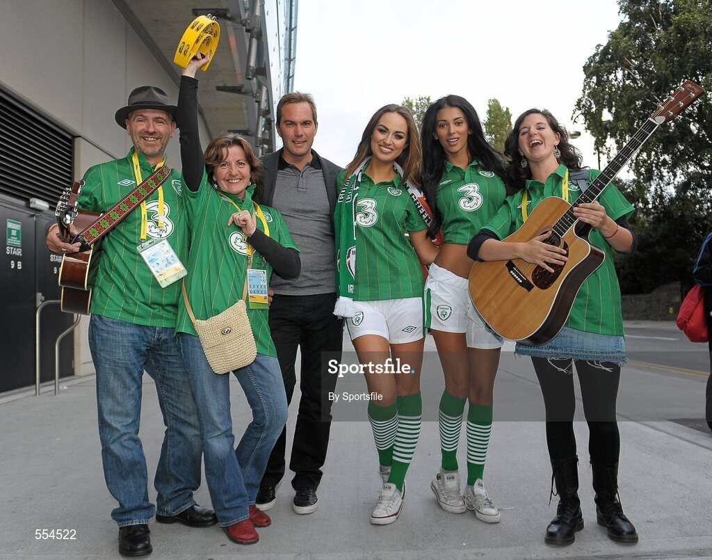 2 September 2011; Former Republic of Ireland star Jason McAteer, who scored the famous winning goal against Holland to secure a place at the 2002 World Cup ten years ago this week, with models Georgia Salpa and Daniella Moyles and fans Alan and Elizabeth Monaghan and Clara Rose, from Kilcloon, Co. Meath, at the Aviva Stadium where they were giving out free jerseys to fans as part of Threes Go Green with Pride campaign that is giving Irish fans the chance to trade in their old Republic of Ireland football jerseys in any Champion Sports store nationwide and get 20 off the brand new Republic of Ireland home jersey. The traded in jerseys will be collected and donated to Friends In Ireland, a charity founded by Marian Finucane that cares for orphans and vulnerable children affected by HIV/AIDS in South Africa. Aviva Stadium, Lansdowne Road, Dublin. Photo by Sportsfile