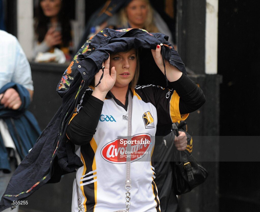 4 September 2011; Kilkenny supporter Maggie Laherty, from Thomastown, Co. Kilkenny, shelters from the rain on her way to the game. Supporters at the GAA Hurling All-Ireland Championship Finals, Croke Park, Dublin. Picture credit: Dáire Brennan / SPORTSFILE