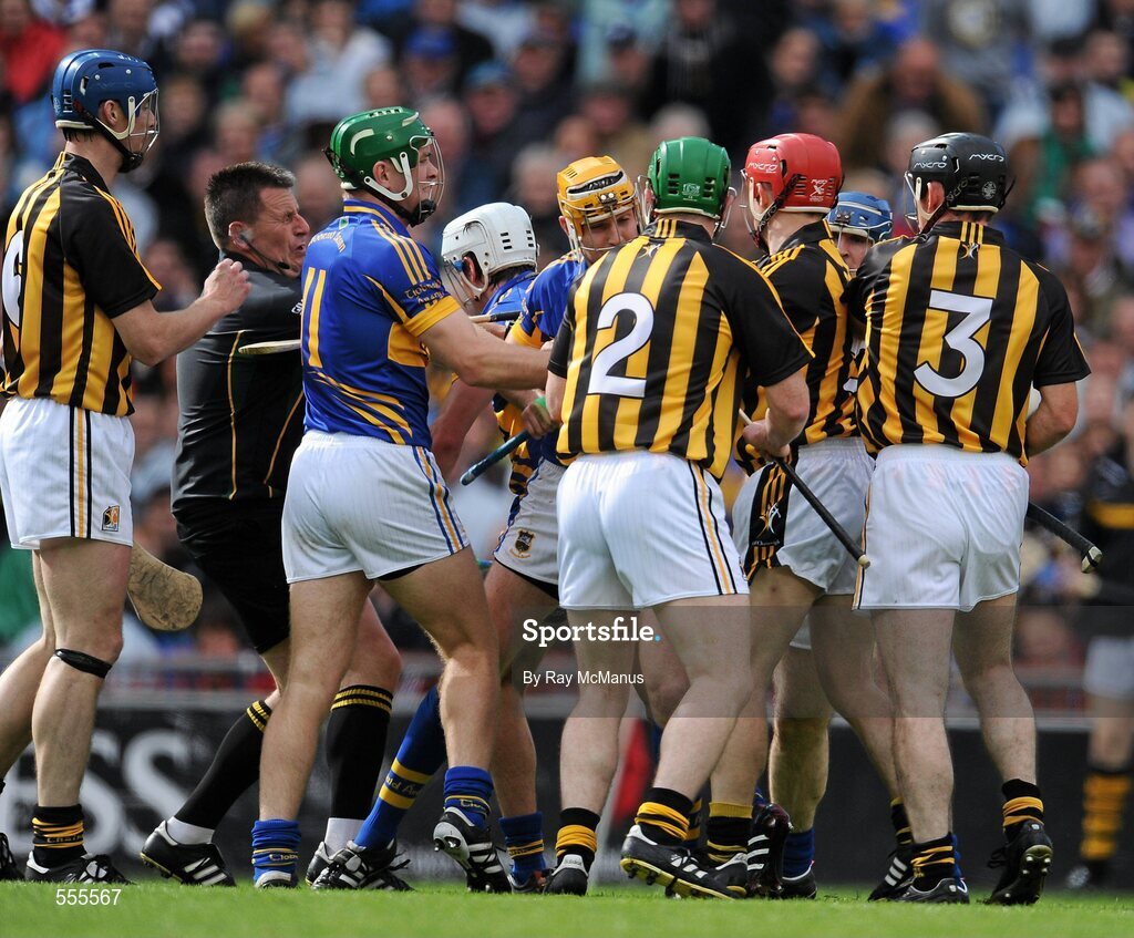 4 September 2011; Referee Brian Gavin runs to seperate Tipperary and Kilkenny players. He received an accidental clip which resulted in a few minutes delay as he was attended to by the two team doctors. GAA Hurling All-Ireland Senior Championship Final, Kilkenny v Tipperary, Croke Park, Dublin. Picture credit: Ray McManus / SPORTSFILE