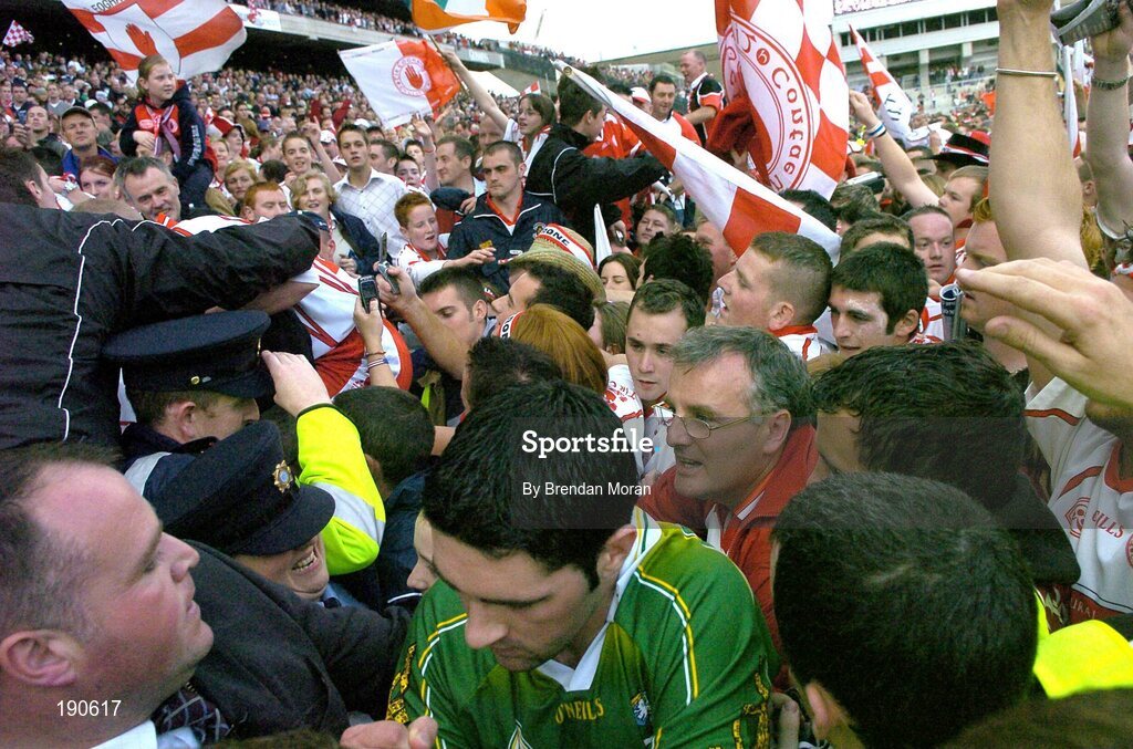 25 September 2005; Kerry player Bryan Sheehan, bottom, is helped by Security personnel and Gardai to get back to the dressing rooms after the game. Bank of Ireland All-Ireland Senior Football Championship Final, Kerry v Tyrone, Croke Park, Dublin. Picture credit; Brendan Moran / SPORTSFILE *** Local Caption *** Any photograph taken by SPORTSFILE during, or in connection with, the 2005 Bank of Ireland All-Ireland Senior Football Final which displays GAA logos or contains an image or part of an image of any GAA intellectual property, or, which contains images of a GAA player/players in their playing uniforms, may only be used for editorial and non-advertising purposes.  Use of photographs for advertising, as posters or for purchase separately is strictly prohibited unless prior written approval has been obtained from the Gaelic Athletic Association.