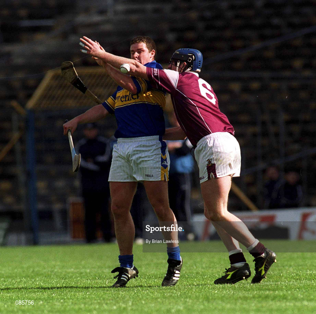 14 April 2002; John Carroll of Tipperary is tackled by Liam Hodgins of Galway during the Allianz National Hurling League Quarter-Final match between Galway and Tipperary at Semple Stadium in Thurles, Tipperary. Photo by Brian Lawless/Sportsfile