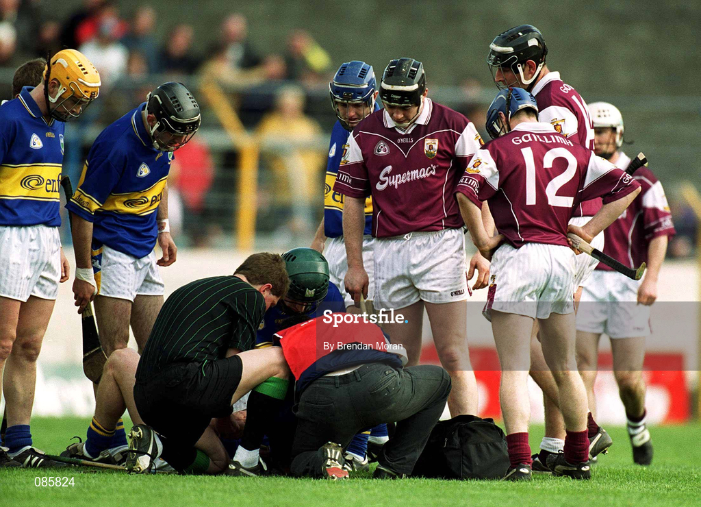 14 April 2002; Galway and Tipperary players gather around as Eamonn Corcoran of Tipperary is attended to by medical staff during the Allianz National Hurling League Quarter-Final match between Galway and Tipperary at Semple Stadium in Thurles, Tipperary. Photo by Brendan Moran/Sportsfile