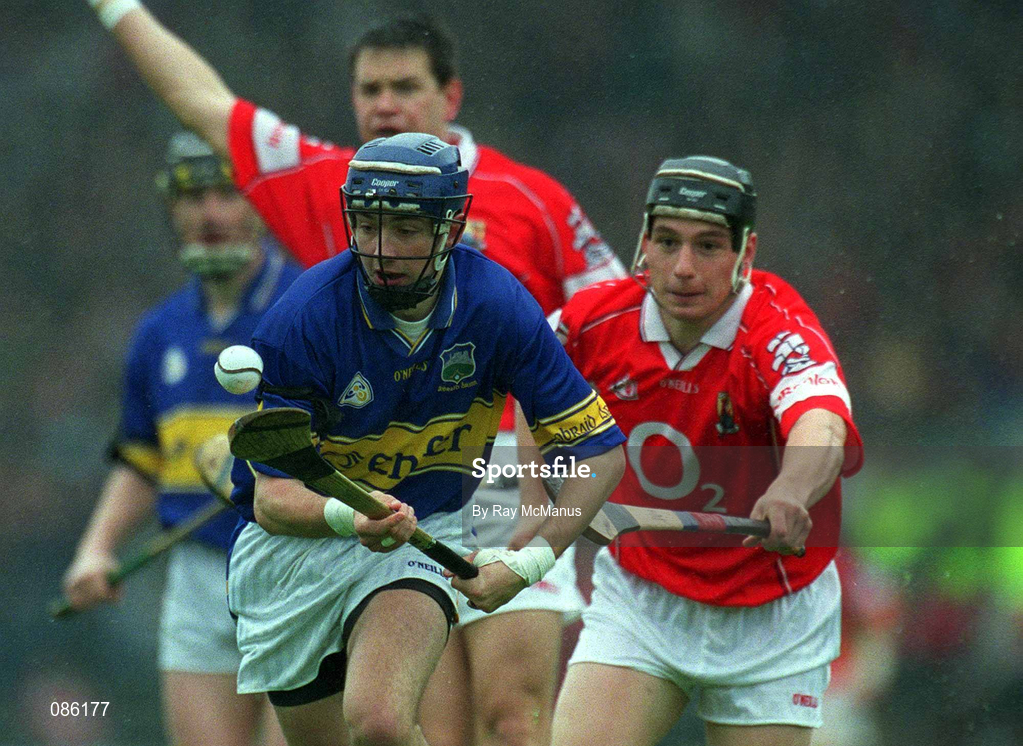 21 April 2002; Benny Dunne of Tipperary in action against Eamonn Collins of Cork during the Allianz National Hurling League Semi-Final match between Cork and Tipperary at Páirc Uí Chaoimh in Cork. Photo by Ray McManus/Sportsfile