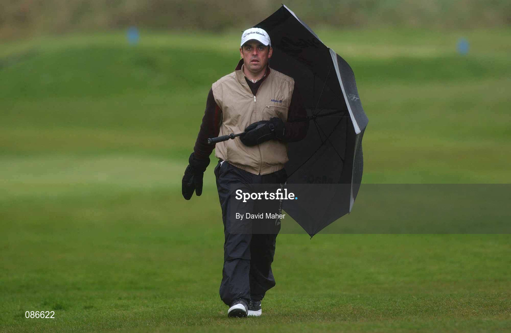 27 April 2002; Paul McGinley uses his umbrella to shield from the rain as he walks toward his ball on the 10th fairway during day three of the Smurfit Irish PGA Championship at Westport Golf Club in Westport, Mayo. Photo by David Maher/Sportsfile