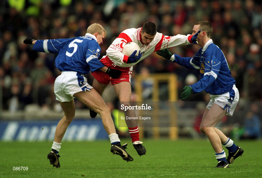28 April 2002; Ryan McMenamin of Tyrone in action against Michael Bridges, 5, and Paul Galligan of Cavan during the Allianz National Football League Division 1 Final match between Tyrone and Cavan at St Tiernach's Park in Clones, Monaghan. Photo by Damien Eagers/Sportsfile