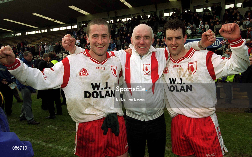 28 April 2002; Tyrone players Stephen O'Neill, left, and Brian Robinson celebrate with Tyrone supporter Brendan McCann after the Allianz National Football League Division 1 Final match between Tyrone and Cavan at St Tiernach's Park in Clones, Monaghan. Photo by Damien Eagers/Sportsfile