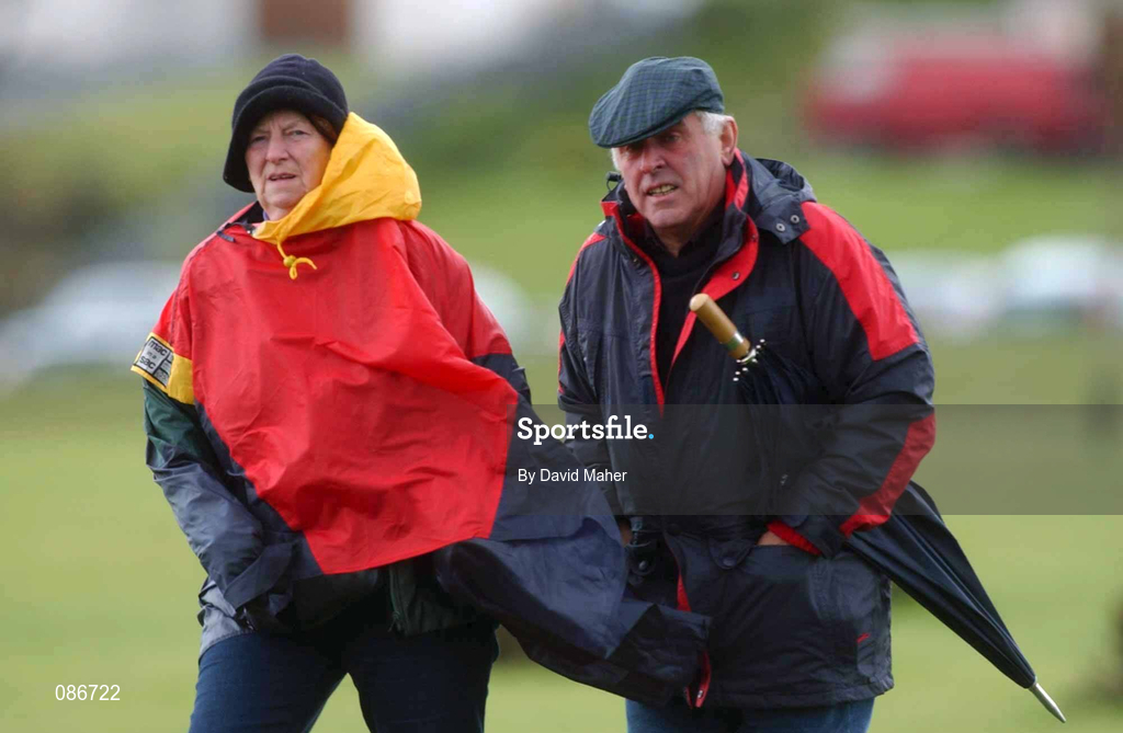28 April 2002; Spectators shield themselves from the bad weather during the final round on day four of the Smurfit Irish PGA Championship at Westport Golf Club in Westport, Mayo. Photo by David Maher/Sportsfile