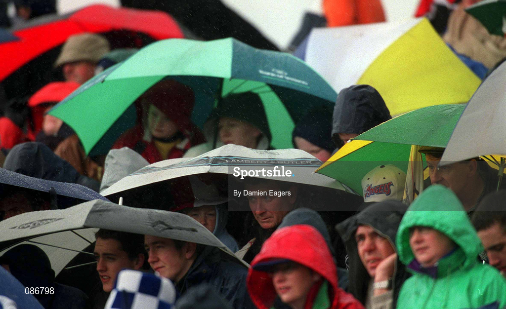 28 April 2002; Supporters shelter from the rain during the Allianz National Football League Division 1 Final match between Tyrone and Cavan at St Tiernach's Park in Clones, Monaghan. Photo by Damien Eagers/Sportsfile