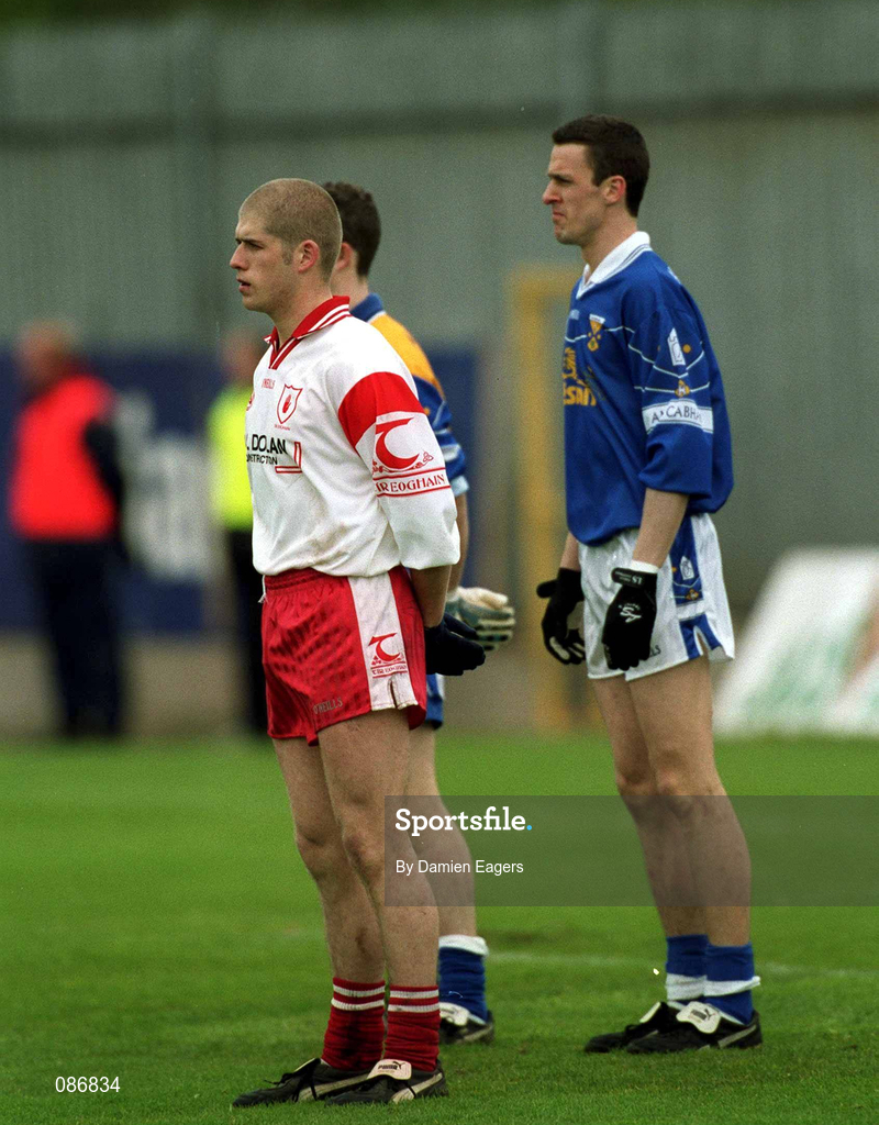 28 April 2002; Kevin Hughes of Tyrone and Thomas Prior of Cavan stand for the playing of the National Anthem prior to the Allianz National Football League Division 1 Final match between Tyrone and Cavan at St Tiernach's Park in Clones, Monaghan. Photo by Damien Eagers/Sportsfile