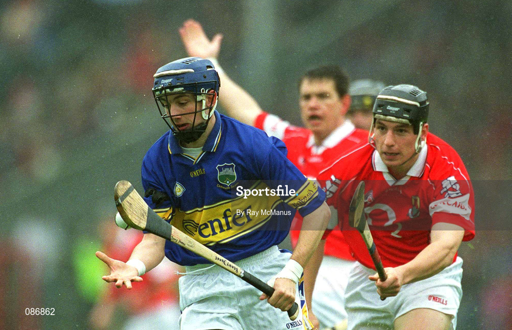 21 April 2002; Benny Dunne of Tipperary in action against Eamonn Collins of Cork during the Allianz National Hurling League Semi-Final match between Cork and Tipperary at Páirc Uí Chaoimh in Cork. Photo by Ray McManus/Sportsfile