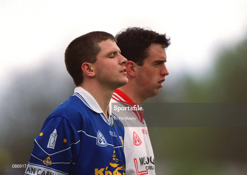 28 April 2002; Larry Reilly of Cavan and Brian Robinson of Tyrone stand for the playing of the National Anthem prior to the Allianz National Football League Division 1 Final match between Tyrone and Cavan at St Tiernach's Park in Clones, Monaghan. Photo by Pat Murphy/Sportsfile