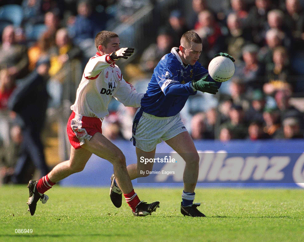 28 April 2002; Paul Galligan of Cavan in action against Philip Jordan of Tyrone during the Allianz National Football League Division 1 Final match between Tyrone and Cavan at St Tiernach's Park in Clones, Monaghan. Photo by Damien Eagers/Sportsfile