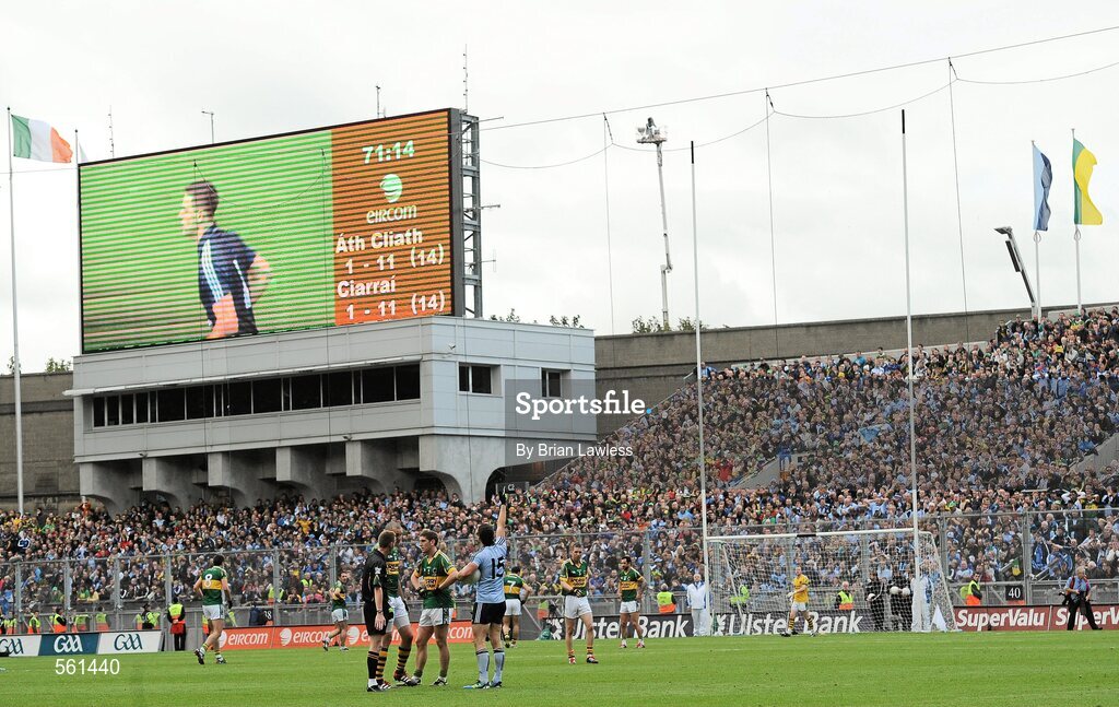18 September 2011; Kerry players Killian Young and Kieran Donaghy remonstrate with referee Joe McQuillan while Dublin's Alan Brogan awaits the arrival of Dublin goalkeeper Stephen Cluxton, seen on the big screen, to take a free kick. Cluxton subsequently scored the free kick to win the match. GAA Football All-Ireland Senior Championship Final, Kerry v Dublin, Croke Park, Dublin. Picture credit: Brian Lawless / SPORTSFILE