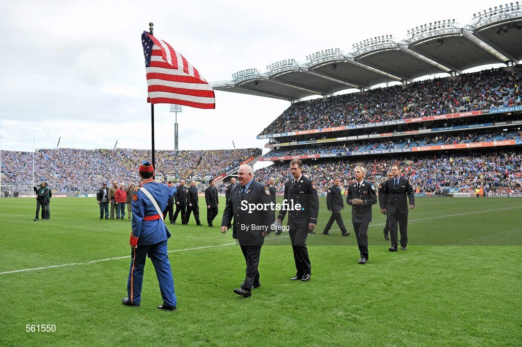 18 September 2011; Members of the New York Fire Department being led from the field by a member of the Artane School of Music band after being presented to the crowd. GAA Football All-Ireland Senior Championship Final, Kerry v Dublin, Croke Park, Dublin. Picture credit: Barry Cregg / SPORTSFILE