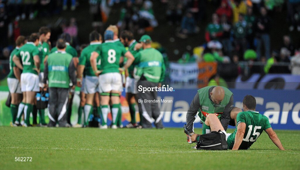 25 September 2011; Ireland full-back Rob Kearney is attended to by team doctor Dr. Eanna Falvey as the rest of the Ireland squad gather together after Russia scored a try. 2011 Rugby World Cup, Pool C, Ireland v Russia, Rotorua International Stadium, Rotorua, New Zealand. Picture credit: Brendan Moran / SPORTSFILE
