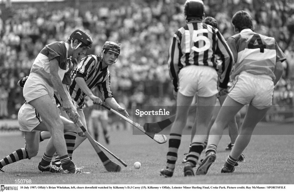 10 July 1987; Offaly's Brian Whelahan, left, clears downfield watched by Kilkenny's DJ Carey (15). Kilkenny v Offaly, Leinster Minor Hurling Final, Croke Park. Picture credit; Ray McManus / SPORTSFILE