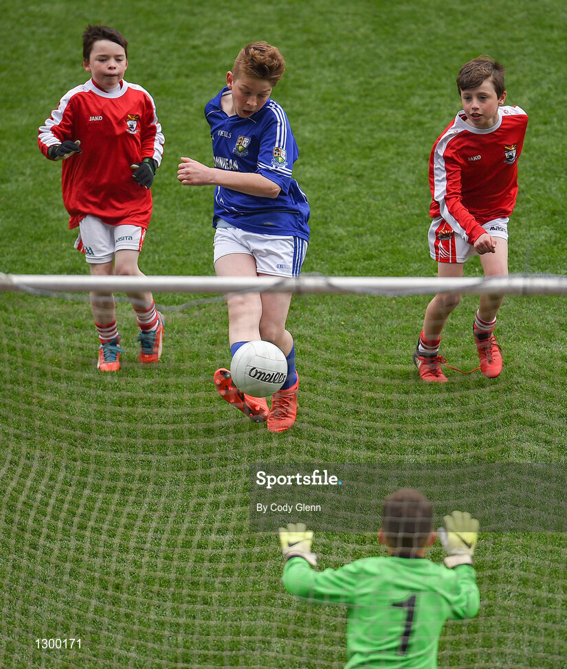 12 April 2017; Caolan O'Connor, representing St. Ronan's GAA Club, Co Roscommon, scores a goal despite the attempts of Shane O'Loughlin, left, Eoghan Healy, right, and goalkeeper Cillian O'Neill, representing Coolera Strandhill GAA Club, Co Sligo, during The Go Games Provincial Days in partnership with Littlewoods Ireland Day 3 at Croke Park in Dublin. Photo by Cody Glenn/Sportsfile
