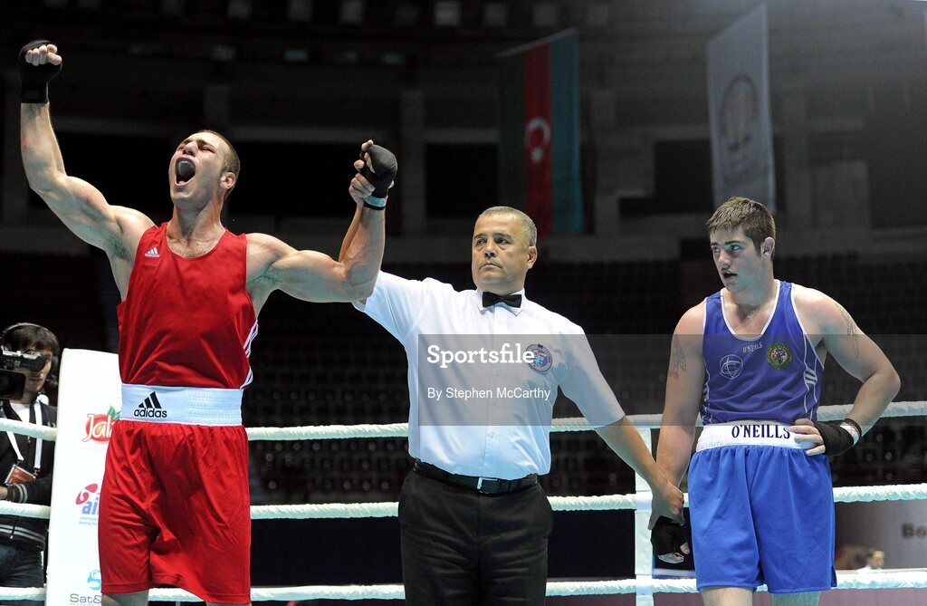 4 October 2011; Referee Bahodir Jumaniyazov, Uzbekistan, raises the hand of Ehsan Rouzbahani, Iran, following his 81kg bout victory over Joe Ward, Moate B.C., Westmeath, representing Ireland. Ward was defeated on countback after the bout ended 15-15. 2011 AIBA World Boxing Championships - Last 16, Joe Ward v Ehsan Rouzbahani. Heydar Aliyev Sports and Exhibition Complex, Baku, Azerbaijan. Picture credit: Stephen McCarthy / SPORTSFILE