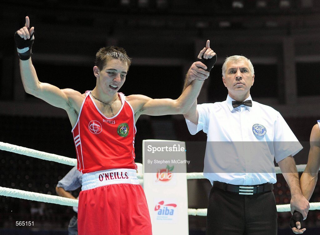 4 October 2011; Michael Conlan, St. John Bosco B.C., Belfast, Antrim, representing Ireland, is announced victorious by referee Vladislav Malyshev following his 52kg bout with Nordine Oubaali, France. Conlan won the contest 20-17 and ensured progression to the Quarter-Finals and also qualification for the London 2012 Olympic Games. 2011 AIBA World Boxing Championships - Last 16, Michael Conlan v Nordine Oubaali. Heydar Aliyev Sports and Exhibition Complex, Baku, Azerbaijan. Picture credit: Stephen McCarthy / SPORTSFILE