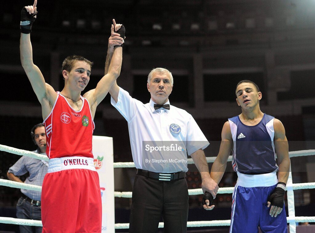 4 October 2011; Michael Conlan, St. John Bosco B.C., Belfast, Antrim, representing Ireland, is announced victorious by referee Vladislav Malyshev following his 52kg bout with Nordine Oubaali, France. Conlan won the contest 20-17 and ensured progression to the Quarter-Finals and also qualification for the London 2012 Olympic Games. 2011 AIBA World Boxing Championships - Last 16, Michael Conlan v Nordine Oubaali. Heydar Aliyev Sports and Exhibition Complex, Baku, Azerbaijan. Picture credit: Stephen McCarthy / SPORTSFILE