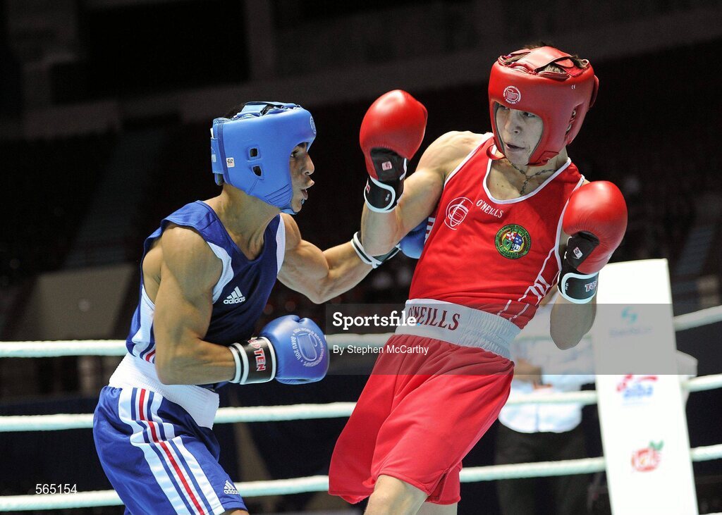 4 October 2011; Michael Conlan, St. John Bosco B.C., Belfast, Antrim, representing Ireland, right, exchanges punches with Nordine Oubaali, France, during their 52kg bout. Conlan won the contest 20-17 and ensured progression to the Quarter-Finals and also qualification for the London 2012 Olympic Games. 2011 AIBA World Boxing Championships - Last 16, Michael Conlan v Nordine Oubaali. Heydar Aliyev Sports and Exhibition Complex, Baku, Azerbaijan. Picture credit: Stephen McCarthy / SPORTSFILE