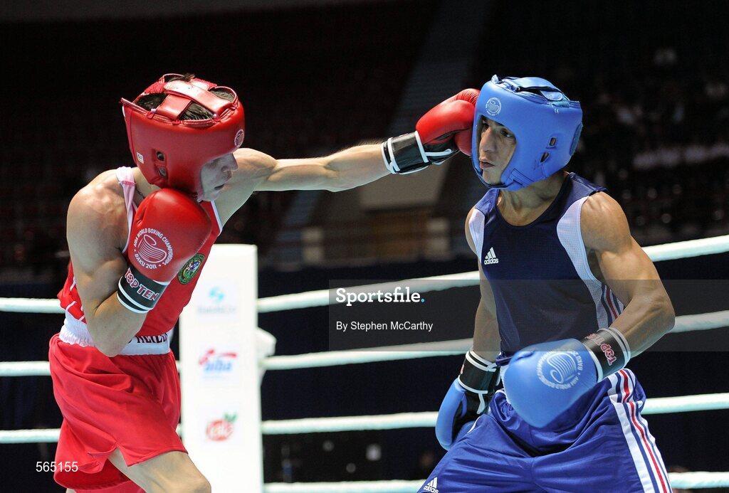 4 October 2011; Michael Conlan, St. John Bosco B.C., Belfast, Antrim, representing Ireland, left, exchanges punches with Nordine Oubaali, France, during their 52kg bout. Conlan won the contest 20-17 and ensured progression to the Quarter-Finals and also qualification for the London 2012 Olympic Games. 2011 AIBA World Boxing Championships - Last 16, Michael Conlan v Nordine Oubaali. Heydar Aliyev Sports and Exhibition Complex, Baku, Azerbaijan. Picture credit: Stephen McCarthy / SPORTSFILE