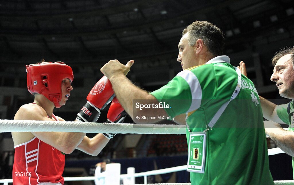 4 October 2011; Michael Conlan, St. John Bosco B.C., Belfast, Antrim, representing Ireland, following his 52kg bout victory over Nordine Oubaali, France, with coaches Billy Walsh and Zaur Antia, right. Conlan won the contest 20-17 and ensured progression to the Quarter-Finals and also qualification for the London 2012 Olympic Games. 2011 AIBA World Boxing Championships - Last 16, Michael Conlan v Nordine Oubaali. Heydar Aliyev Sports and Exhibition Complex, Baku, Azerbaijan. Picture credit: Stephen McCarthy / SPORTSFILE