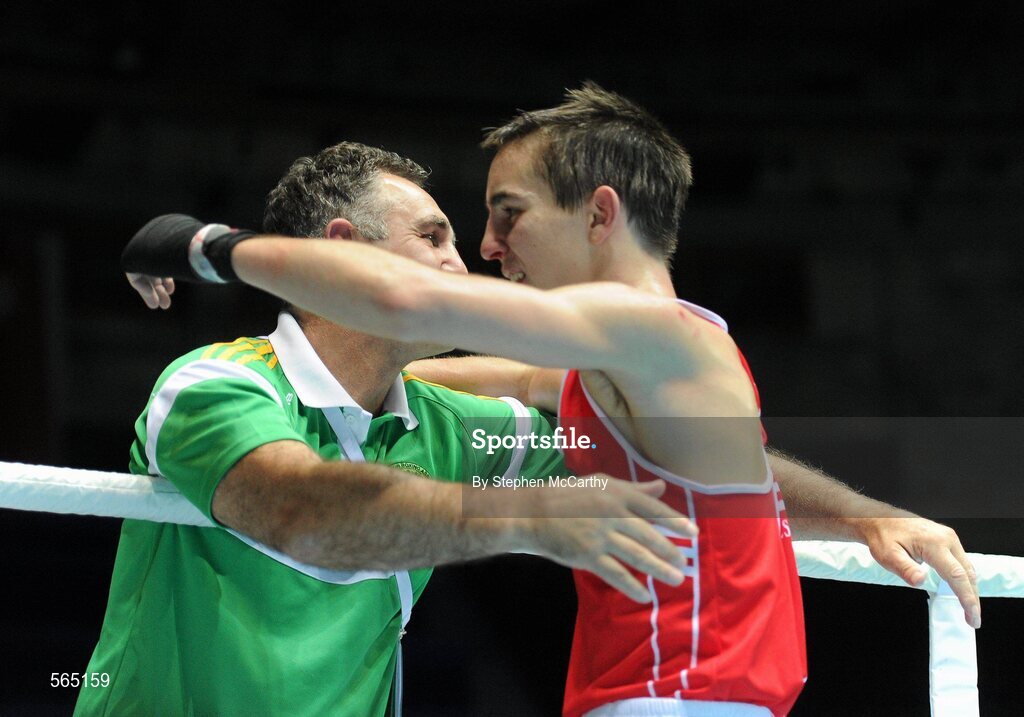 4 October 2011; Michael Conlan, St. John Bosco B.C., Belfast, Antrim, representing Ireland, following his 52kg bout victory over Nordine Oubaali, France, with coach Billy Walsh. Conlan won the contest 20-17 and ensured progression to the Quarter-Finals and also qualification for the London 2012 Olympic Games. 2011 AIBA World Boxing Championships - Last 16, Michael Conlan v Nordine Oubaali. Heydar Aliyev Sports and Exhibition Complex, Baku, Azerbaijan. Picture credit: Stephen McCarthy / SPORTSFILE