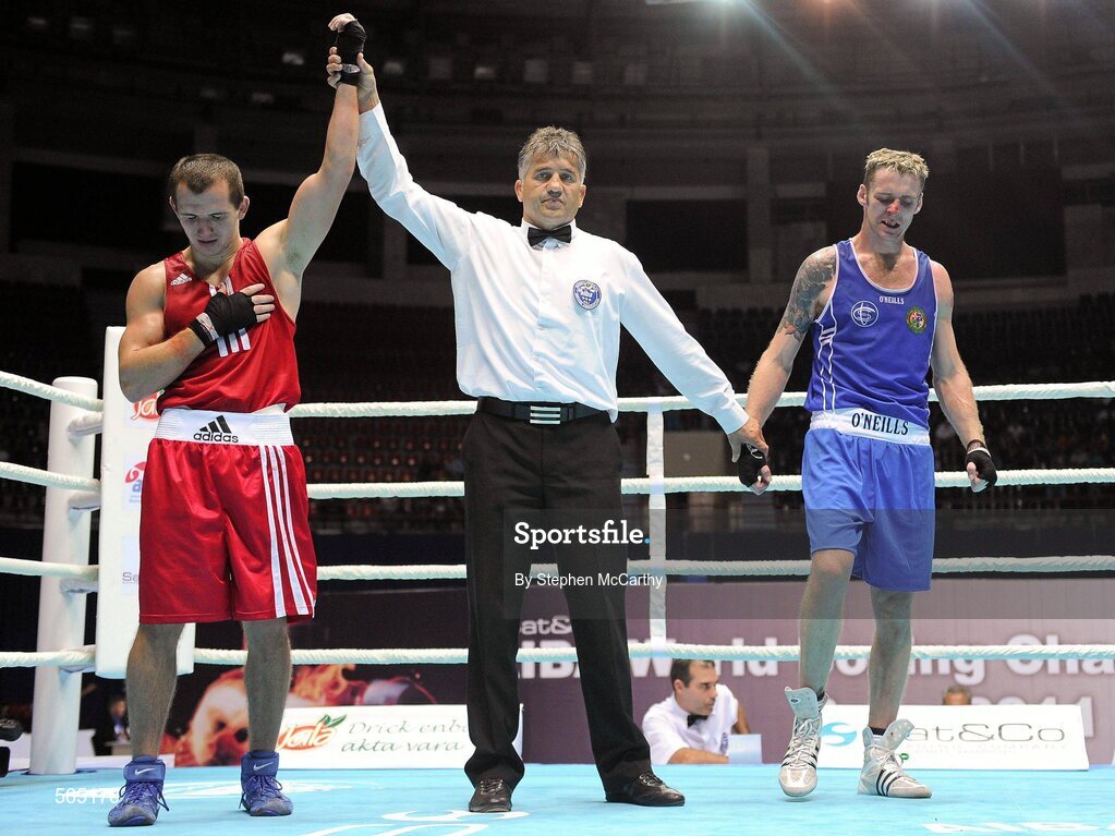 4 October 2011; Referee Martin Tadic, Croatia, raises the hand of Egidijus Kavaliauskas, Lithuania, following his 69kg bout victory over Roy Sheehan, St Michael's Athy B.C., Kildare, representing Ireland. Roy Sheehan was defeated on a score of 11-7. 2011 AIBA World Boxing Championships - Last 16, Roy Sheehan v Egidijus Kavaliauskas. Heydar Aliyev Sports and Exhibition Complex, Baku, Azerbaijan. Picture credit: Stephen McCarthy / SPORTSFILE
