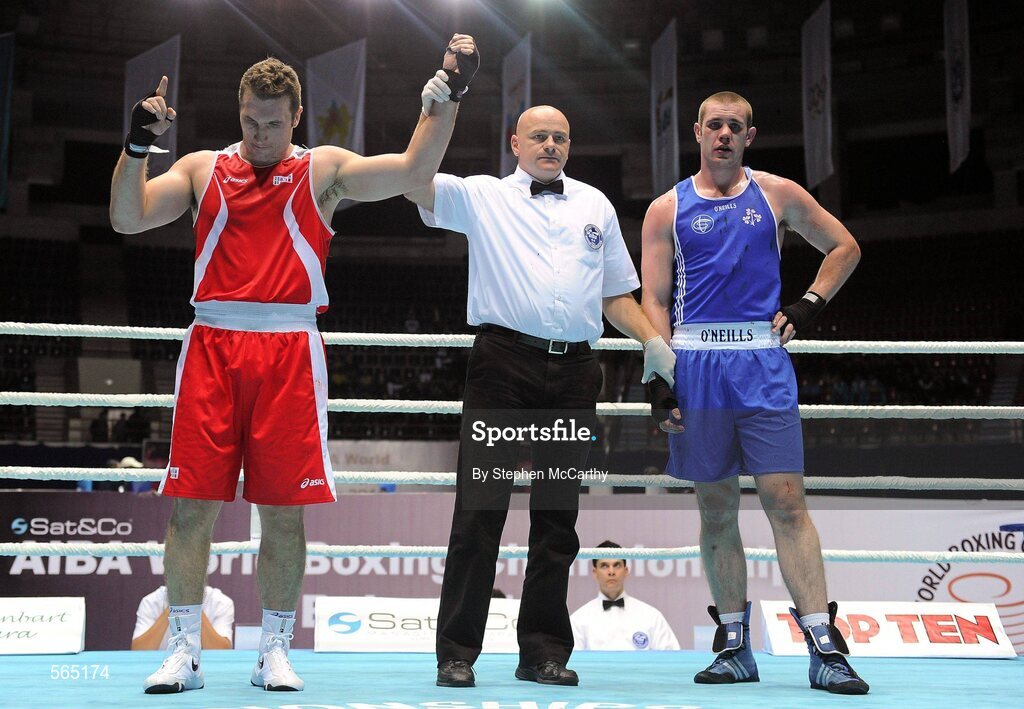 4 October 2011; Referee Tony Germaine, Canada, raises the hand of Roberto Cammerelle, Italy, following his 91+kg bout victory over Con Sheehan, Clonmel B.C., Tipperary, representing Ireland. Sheehan retired during the third round after visiting the medic twice. 2011 AIBA World Boxing Championships - Last 16, Con Sheehan v Roberto Cammerelle. Heydar Aliyev Sports and Exhibition Complex, Baku, Azerbaijan. Picture credit: Stephen McCarthy / SPORTSFILE