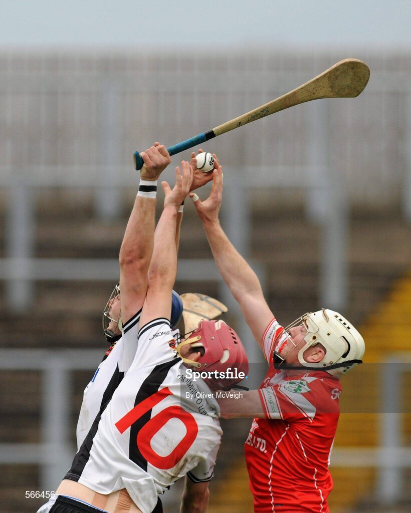 9 October 2011; Patrick McCloskey and Kevin Hinphey, Dungiven Kevin Lynchs, in action against Martin Scullion, Loughgiel Shamrocks. AIB GAA Hurling Ulster Senior Club Championship Semi-Final, Loughgiel v  Dungiven Kevin Lynchs, Casement Park, Belfast, Co. Antrim. Picture credit: Oliver McVeigh / SPORTSFILE