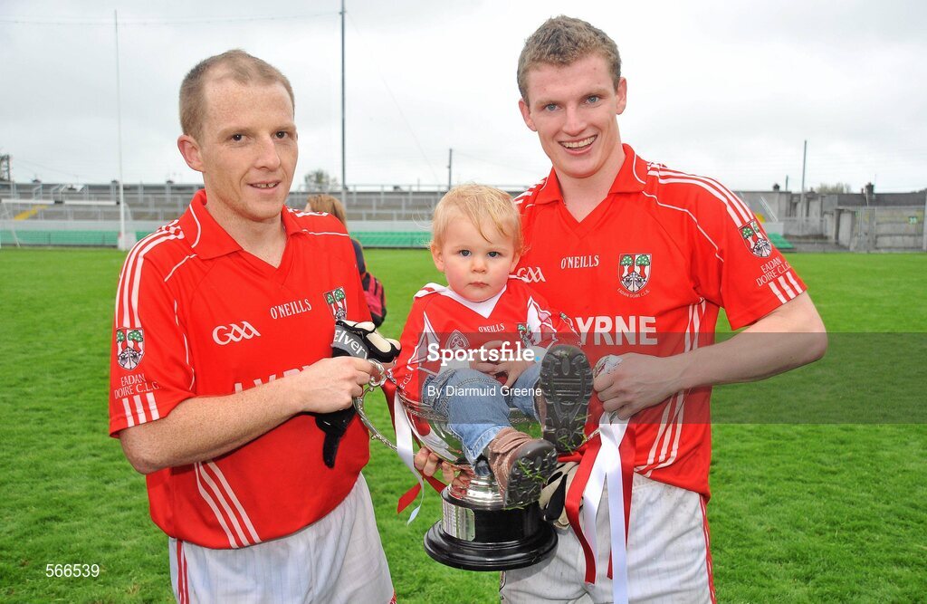 9 October 2011; Edenderry players Wayne Mooney, left, and Sean Pender, celebrate after victory over Clara with Eoin Plunkett, aged 18 months, from Edenderry, sitting in the cup. Tullamore Court Hotel Senior Football Final, Clara v Edenderry, O'Connor Park, Tullamore, Co. Offaly. Picture credit: Diarmuid Greene / SPORTSFILE