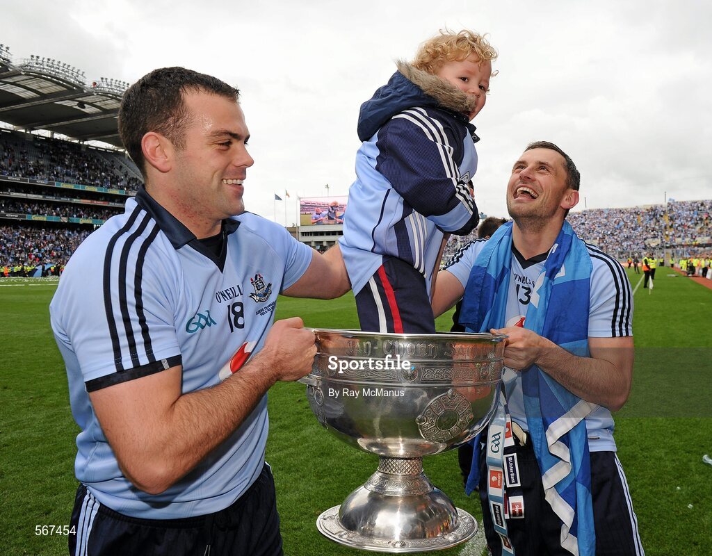 18 September 2011; Dublin's Paul Casey, left, and Alan Brogan hold the Sam Maguire Cup with Alan's son Jamie, aged 2. GAA Football All-Ireland Senior Championship Final, Kerry v Dublin, Croke Park, Dublin. Picture credit: Ray McManus / SPORTSFILE