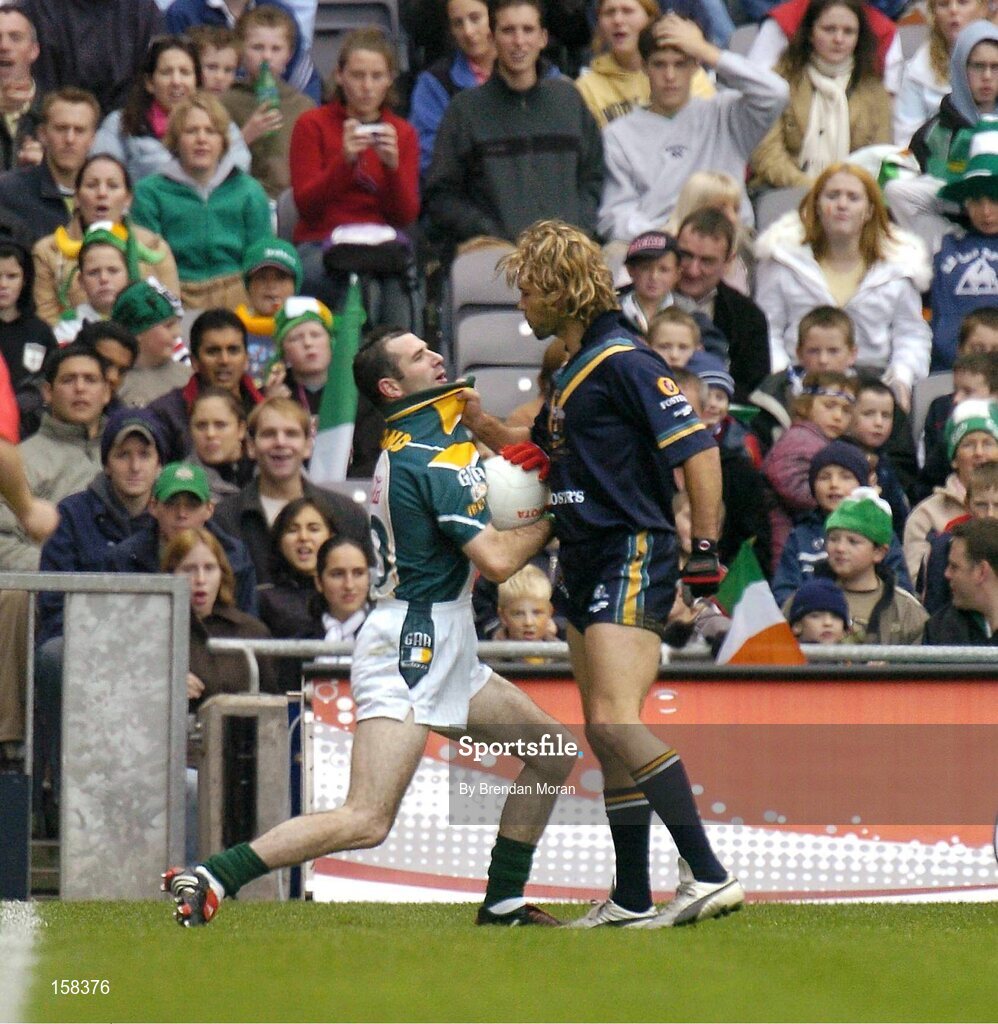 17 October 2004; Steven McDonnell, Ireland, in action against Mark McVeigh, Australia. Coca Cola International Rules Series 2004, First Test, Ireland v Australia, Croke Park, Dublin. Picture credit; Brendan Moran / SPORTSFILE *** Local Caption *** Any photograph taken by SPORTSFILE during, or in connection with, the 2004 Coca Cola International Rules Series which displays GAA logos or contains an image or part of an image of any GAA intellectual property, or, which contains images of a GAA player/players in their playing uniforms, may only be used for editorial and non-advertising purposes.  Use of photographs for advertising, as posters or for purchase separately is strictly prohibited unless prior written approval has been obtained from the Gaelic Athletic Association.