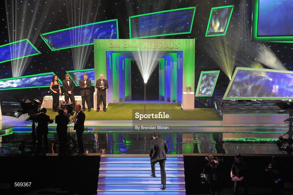21 October 2011; Dublin footballer Michael Darragh Macauley walks up onto the stage to receive his award from Uachtarán CLG Criostóir Ó Cuana at the GAA GPA All-Star Awards 2011 sponsored by Opel. National Convention Centre, Dublin. Picture credit: Brendan Moran / SPORTSFILE
