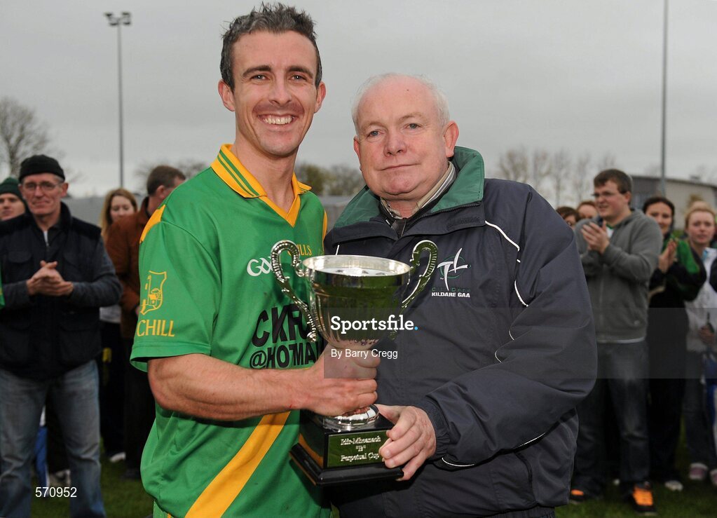 30 October 2011; Kill captain Ronan Kelly receives the trophy from Chairman of the Kildare Hurling Board Paddy Lawlor after the game. Intermediate B Championship Final, Kill v Confey, Naas GAA Ground, Co. Kildare. Picture credit: Barry Cregg / SPORTSFILE